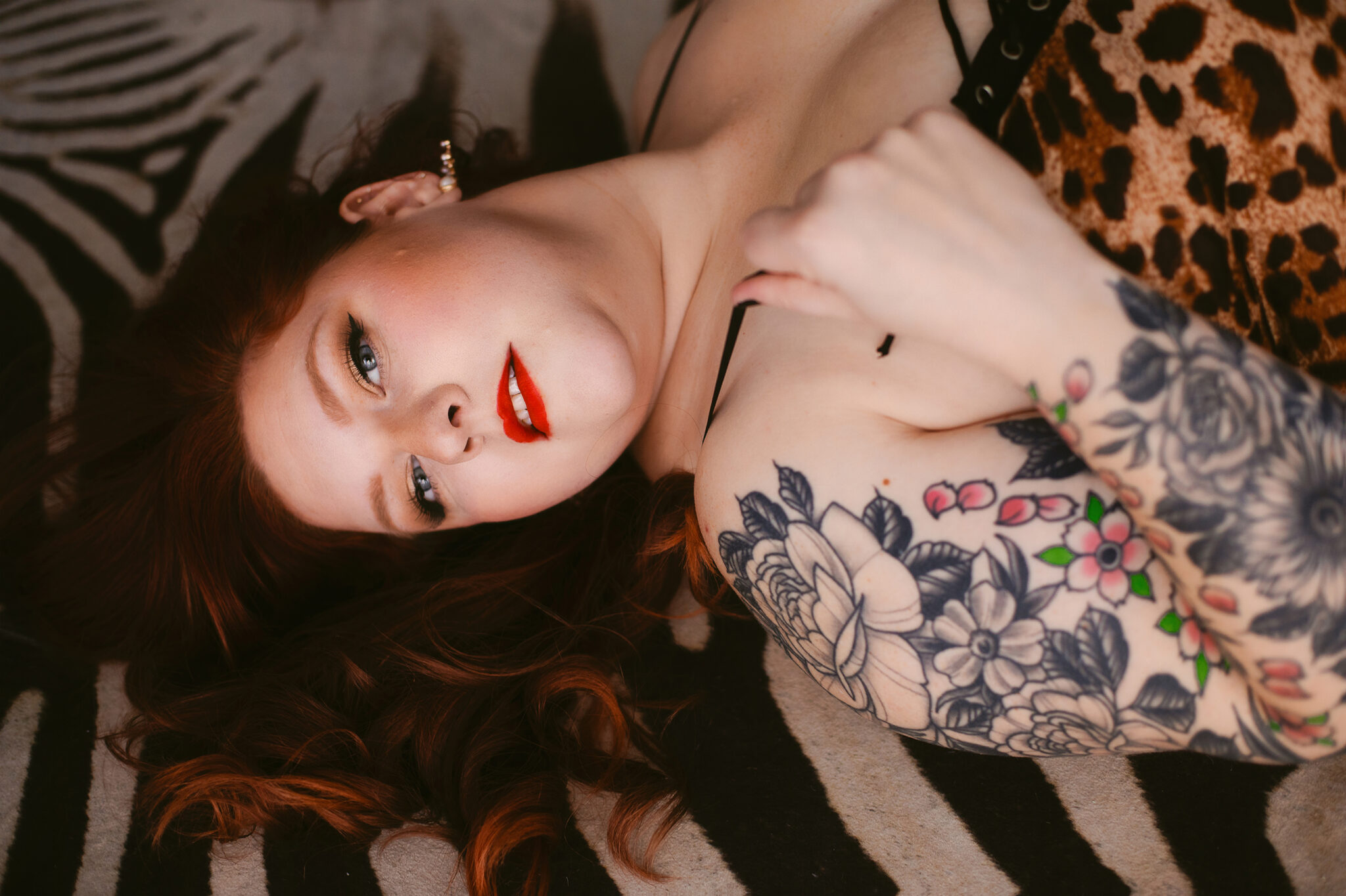 A woman with a fresh hair cut from a Bentonville hair salon poses on a zebra rug.